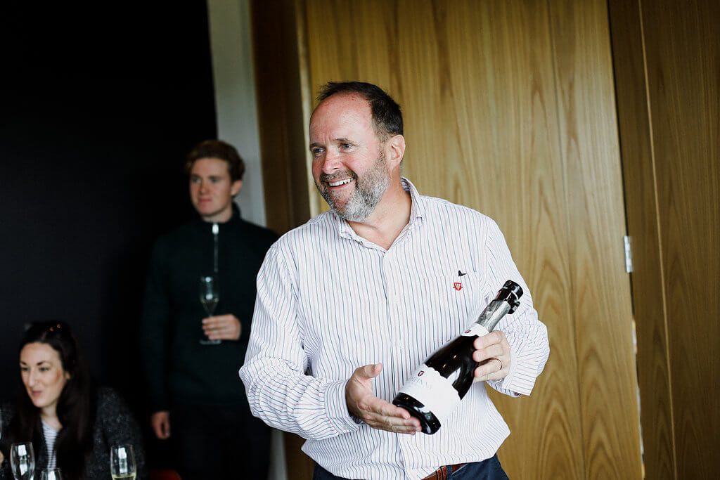 Mark Driver Holding a Bottle of Rathfinny Wine