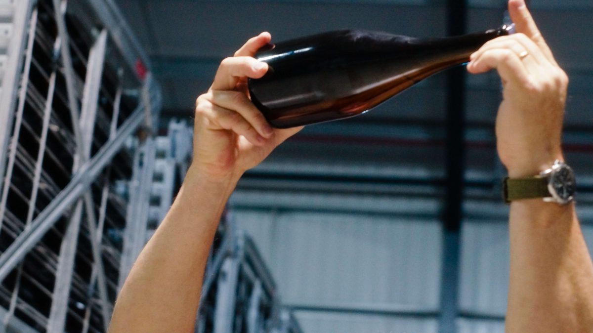 Mark Holding up Bottle to the Light